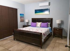 Un dormitorio con una cama grande con almohadas moradas. en Casa Margarita Pool, Billiards Just Steps from the Beach, en Puerto Peñasco 45 fotos más