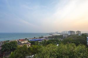 a view of a beach with buildings and the ocean at Harbourview Visakhapatnam RK Beach in Visakhapatnam