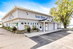 a large white building with a parking lot at Upper Level Lakeview suite in Lake City