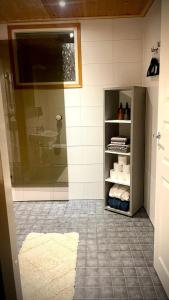 a bathroom with a shower and a sink at Borealis Forest House with Private Sauna in Rovaniemi +7 photos