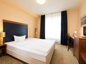 Кровать или кровати в номере ACHAT Hotel Buchholz Hamburg