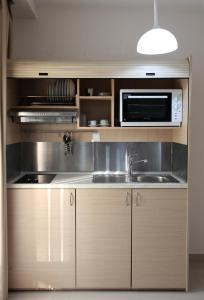 a kitchen with a sink and a microwave at Kochili Seashell Apartments in Siviri +17 photos