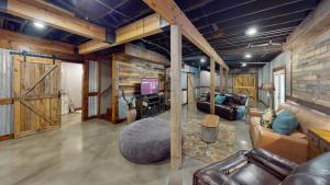 a living room with leather furniture and wooden walls at 2196 Major Loring Way SW Marietta in Macland