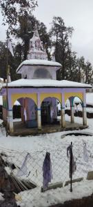 a small building in a park with snow on the ground at Nag Tibba Trek - Three Sixty Views in Miānī +2 photos