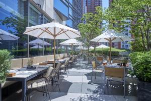 a restaurant with tables and chairs with umbrellas at Grand Hyatt Tokyo in Tokyo