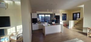 a kitchen with white cabinets and a counter in a room at مزرعة صوفيا السلط in Al Salt