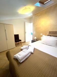 a bedroom with a bed with towels on it at Eli's House in Lazise sul Garda in Lazise +32 photos