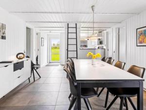 a kitchen and dining room with a table and chairs at 5 star holiday home in Nordborg in Nordborg
