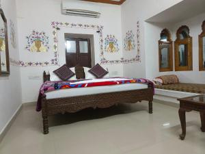 a room with a bed in the middle of a room at Hotel Kesar Dunes in Jaisalmer