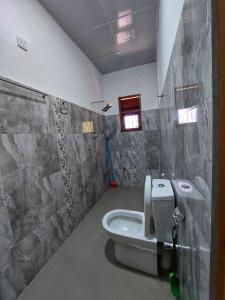 a bathroom with a toilet and a sink at Wijaya Home Stay in Anuradhapura