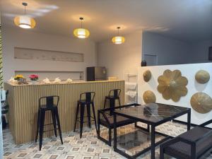 a dining room with a table and chairs and a counter at Camping House Kohkood in Ban Khlong Mat