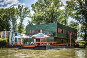 a green building on the side of a river at Green House Hostel in Belgrade