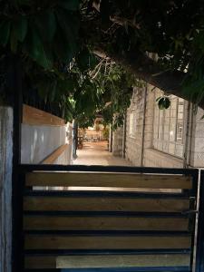 a wooden bench sitting in front of a building at Midtown Lweibdeh Hostel in Amman