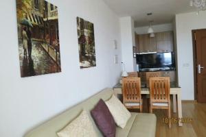 a living room with a couch and a kitchen at Morski Briz in Balchik