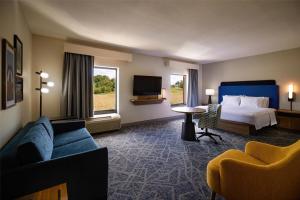 a hotel room with a bed and a couch and a tv at Hampton Inn & Suites Radcliff/Fort Knox in Radcliff