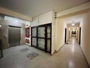 an empty hallway with glass doors in a building at Premanand mharaj darsan Vrindavan Dham in Vrindāvan +3 photos