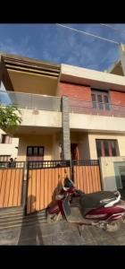 two scooters parked in front of a house at Shree Gowthameshwara Nilaya in Chikmagalūr
