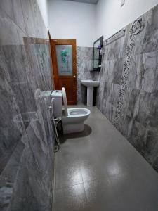 a bathroom with a toilet and a sink at Wijaya Home Stay in Anuradhapura