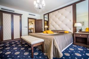 a bedroom with a large bed with a large headboard at Hotel Palace Marina Dinevi in Sveti Vlas