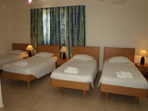 a room with two beds and two lamps at Rivotorto Retreat House in Birkirkara