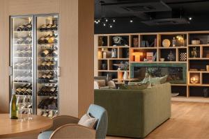 a living room with a couch and a wine cellar at Hôtel de la Plage in Erquy