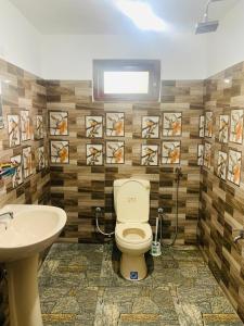 a bathroom with a toilet and a sink at Secret Pearl Ella in Bandarawela