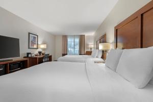 a hotel room with two beds and a flat screen tv at Comfort Inn & Suites Carbondale on the Roaring Fork in Carbondale +57 photos