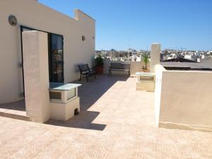 a balcony of a house with a view of the city at Rivotorto Retreat House in Birkirkara