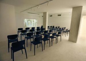 a room with rows of chairs in a building at Hotel Hello Plovdiv - Free Parking and Pet Friendly in Plovdiv