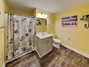 a bathroom with a sink and a toilet and a shower curtain at Put-in-Bay Waterfront Condo #206 in Put-in-Bay