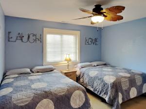a bedroom with two beds and a ceiling fan at Put-in-Bay Waterfront Condo #206 in Put-in-Bay +24 photos