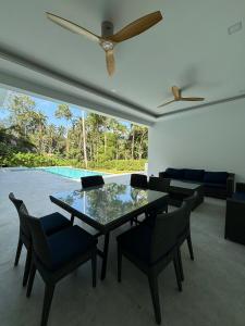 a living room with a glass table and chairs at Villa Lamai 4 bedrooms in Koh Samui 