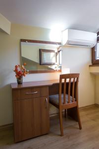 a desk with a mirror and a wooden chair at Hera Guest House in Chiflik