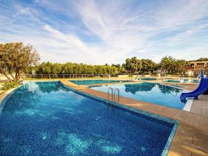 a large swimming pool with blue water at Mobile Home in Novalja near Pebble Beach in Novalja