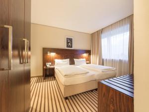 Postel nebo postele na pokoji v ubytování Hotel an der Oper + 37 fotografií