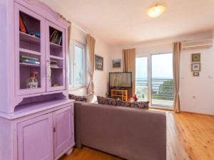 a living room with a large purple cabinet and a window at Villa in Tučepi with Pool near Seabeach in Tučepi