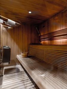 a bathroom with a wooden floor and a wooden wall at Les Trois Vallées, a Beaumier hotel in Courchevel