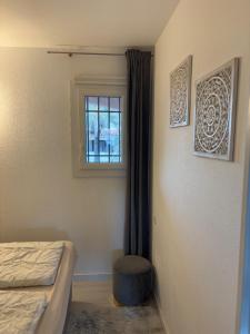 a bedroom with a bed and a window and a stool at La VIE EST BELLE in Gassin +36 photos