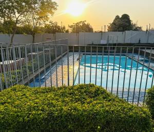 a swimming pool with a fence around it at suarez homes in Chartwell