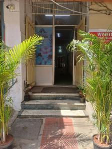 an entrance to a building with plants in front of it at AGH Residency Triplicane in Chennai