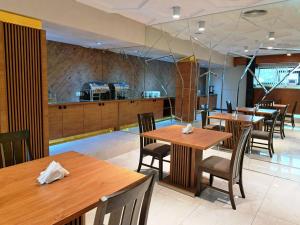 a dining room with wooden tables and chairs at Hotel Panorama Gareji in Sagarejo