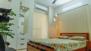 a bedroom with a bed and a dresser and a mirror at Family Space in Dhaka