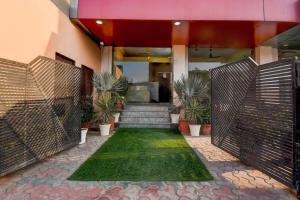 a entrance to a building with a gate and plants at Super Collection O Sunder Nagar Golvyas Formerly Hotel Vanshil in Jaipur