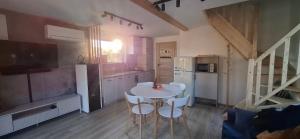 a kitchen with a table and chairs in a room at Domek KAMA in Giżycko