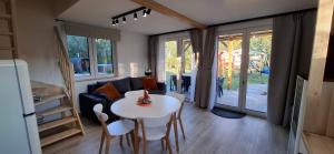 a living room with a white table and chairs at Domek KAMA in Giżycko