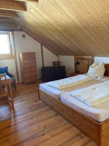 ein Schlafzimmer mit zwei Betten und einer Holzdecke in der Unterkunft Öko Ferienwohnung HolzLehmSonne in Schwarzenbach an der Saale