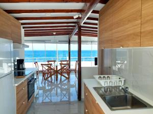 a kitchen with a view of the ocean at Seafront Panorama Penthouse in Chios