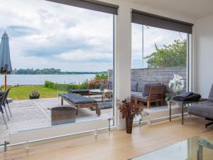 a living room with a view of the water at 8 person holiday home in Præstø in Præstø