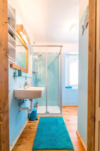 a bathroom with a sink and a shower at La Casa dei Botiri in Rocca Pietore