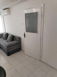 a living room with a door with a cross on it at Stan dve sobe, kupatilo, hodnik, kuninja, klima, masina za ves, parking, strogi centar in Negotin